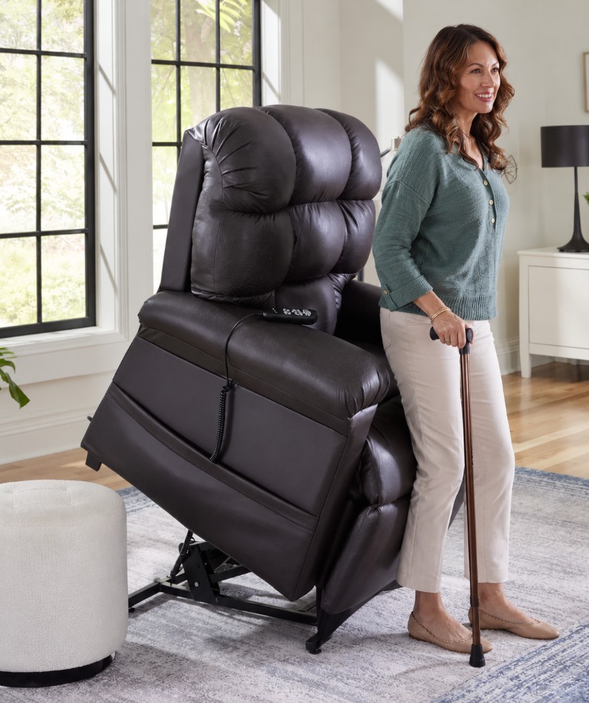 Woman standing from a medical-grade power lift recliner with a cane at home