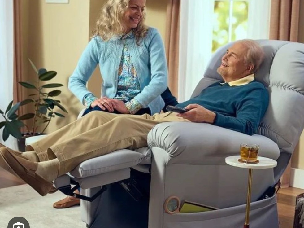 Couple at home with a reclined medical-grade lift chair